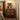 Wood Nightstand Image. A 2 drawer nightstand by the bedside in a warm lighted bedroom scenery