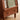 Wood Nightstand Image. Brown nightstand with fluted glass accent, small shelf handle on upper drawer, and pinball handle of lower shelf.