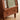 Wood Nightstand Image. Brown nightstand with fluted glass accent, small shelf handle on upper drawer, and pinball handle of lower shelf.
