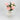 Angled top view of white ceramic vase with artificial peonies