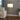 Brass floor lamp with white shade next to a beige sofa in modern living room