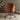 Back View of the Brown Leather Office Chair in a Comfy indoor Setting with Minimal Decor