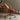 Side View of the Brown Leather Office Chair in a Comfy indoor Setting
 