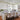 Brushed nickel pendant lights above white kitchen island with granite countertop
