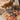 Cat standing on boho jute rug near wooden chair