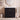 CharmyDecor matte black 36 inch bathroom vanity with sink and fluted fronts beneath a round bathroom mirror.