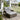 Outdoor patio furniture set on a deck with a house in the background