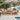 CharmyDecor 4 piece patio conversation set with beige cushions and natural acacia wood beside swimming pool