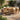 Charmydecor 7-piece acacia wood outdoor dining set with brown rope chairs and beige cushions on a sunny patio