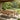 Charmydecor 7-piece acacia wood outdoor dining set with handwoven rope chairs and beige cushions on a covered backyard patio