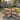 charmydecor 7-piece acacia wood outdoor dining set with rope armchairs and beige cushions on backyard patio
