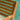 Close-up of a wooden chair with a blurred pool background