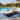 Charmydecor black acacia wood outdoor chaise lounge with cream cushion beside a swimming pool