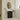 CharmyDecor black chestnut bathroom vanity with white ceramic sink in a bright bathroom beneath a curved mirror
