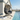 Hanging egg chair with gray cushions by a poolside