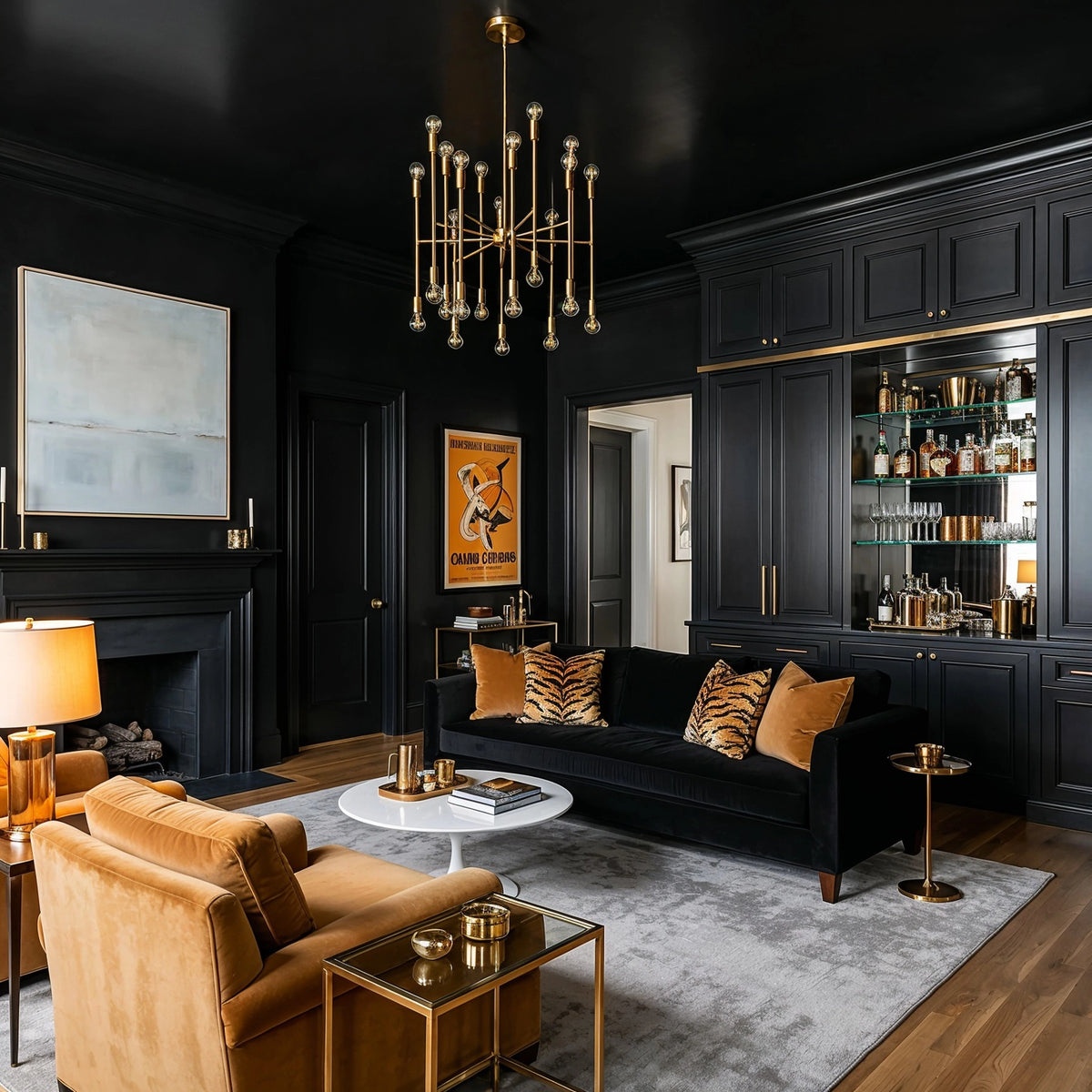 Black living room ideas with black paneled walls and built-in bar, black velvet sofa, caramel velvet chairs, brass chandelier, and gold accents.