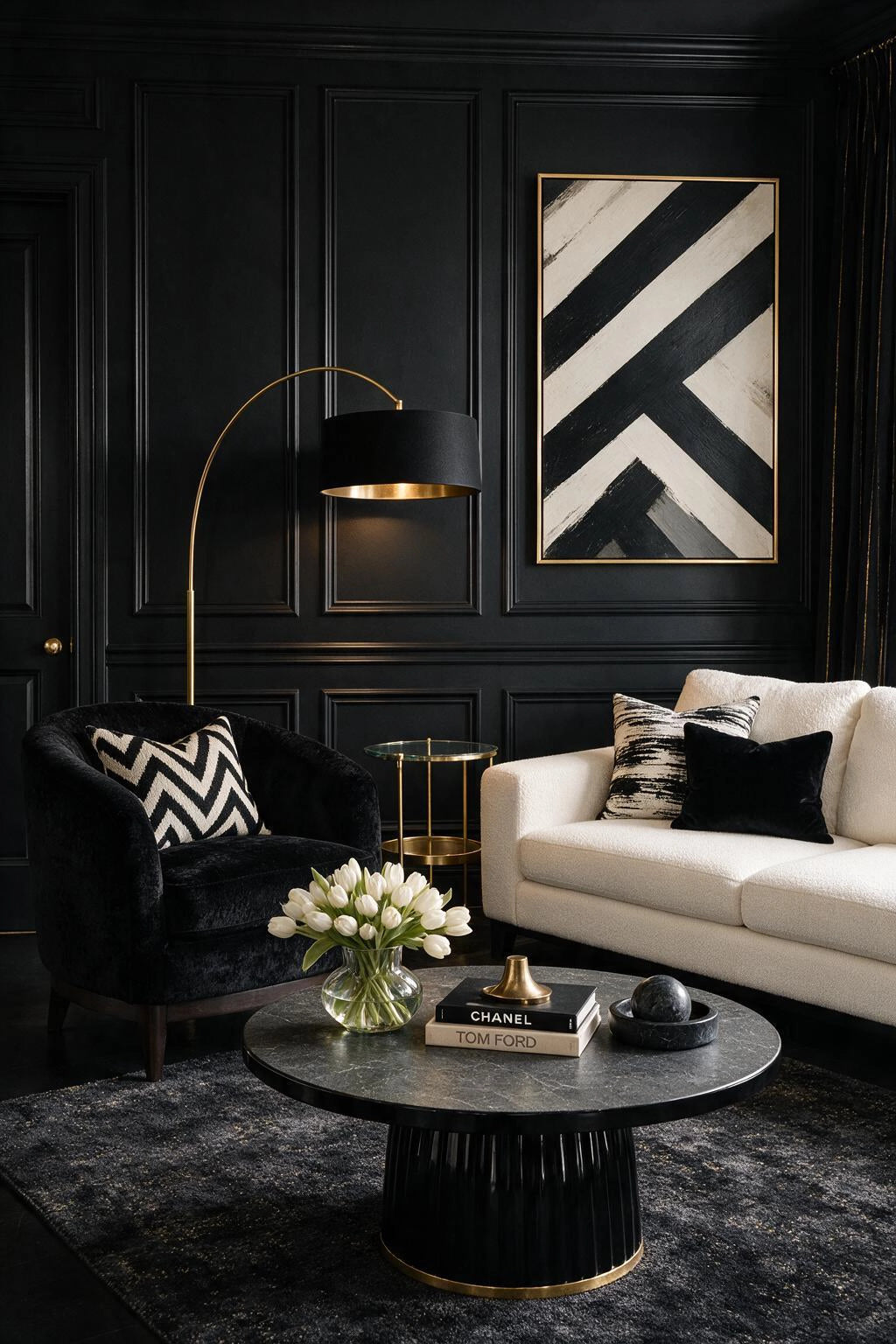 Black living room ideas with paneled black walls, white sofa, black lounge chair, black-and-white artwork, brass floor lamp, and round dark coffee table.