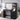 CharmyDecor black makeup vanity in an angled bedroom view showing the storage cabinet and shelves styled with beauty essentials.