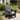 charmydecor black wood-look Adirondack patio chair styled in a flower garden