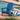 Charmydecor blue folding Adirondack chair styled on a brick pool deck with outdoor pillows