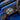 Close-up of a digital audio player on a blue vehicle dashboard
