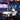 Child in a toy car with a cityscape background