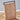 Brown leather chair with a black frame on a wooden floor.