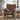Brown leather recliner chair in a living room setting with a plant and side table.