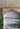 Charmydecor carved arched top detail on distressed farmhouse wood bookshelf showing decorative craftsmanship