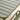 Close-up of a green outdoor chair with slatted backrest