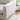 charmydecor close up of rounded white sand fabric sofa armrest with soft upholstered texture