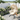 Charmydecor cream cushion hanging egg chair with U-base stand styled in a flower garden patio