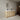 CharmyDecor double sink bathroom vanity styled in a neutral bathroom beneath two oval mirrors, angled room view.