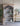 Charmydecor farmhouse arched bookshelf styled with books pottery and vintage decor in neutral living room