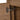 Soft-close hinge close-up on the oak-look cabinet of the CharmyDecor floating double sink bathroom vanity.
