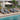 Charmydecor four acacia wood patio chaise lounges with dark gray cushions arranged beside a swimming pool
