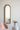 charmydecor gold arched wall mirror styled in a soft bedroom corner