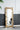 charmydecor gold leaf full length mirror leaning against wall with modern accent chair reflection