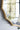 Gold-framed mirror on a white wall with blurred background