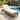 Charmydecor grey brown PE rattan patio chaise lounge with beige cushion beside a swimming pool