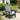 charmydecor grey HDPE Adirondack patio chair styled in a flower garden seating area