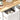 White cabinet with open drawer revealing two ceramic cups, next to a wooden surface with a bottle of coffee.