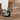 Close-up of a furniture caster wheel with brake mechanism on a wooden floor, labeled 'Universal Wheels'.