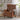 Brown leather armchair in a room with a side table and plants