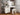 Charmydecor makeup vanity desk shown at an angle with white storage cabinet, lighted mirror, shelves, and stool
