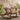 charmydecor Malibu Adirondack rocking chair in natural wood finish styled on an outdoor patio deck