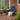 Charmydecor Malibu blue folding Adirondack chair styled on an outdoor brick porch
