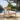 Charmydecor Mallorca acacia wood outdoor club chair with beige cushion beside pool