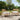 charmydecor Mallorca acacia wood outdoor club chairs with beige cushions on garden patio