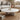 Charmydecor marble round coffee table in white natural marble styled in a neutral living room with sofa and rattan chair
